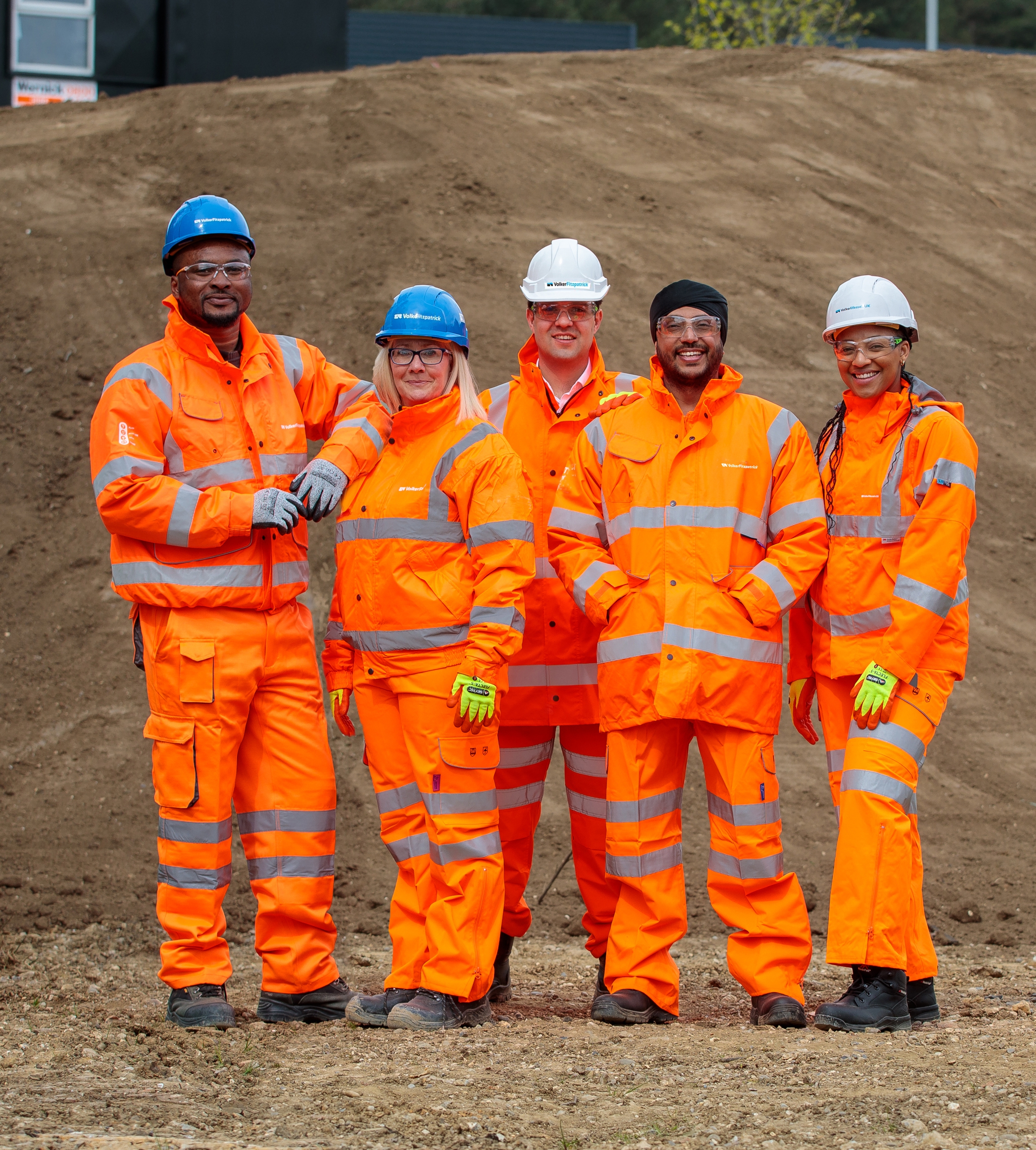 Generic group of people wearing orange PPE on construction site